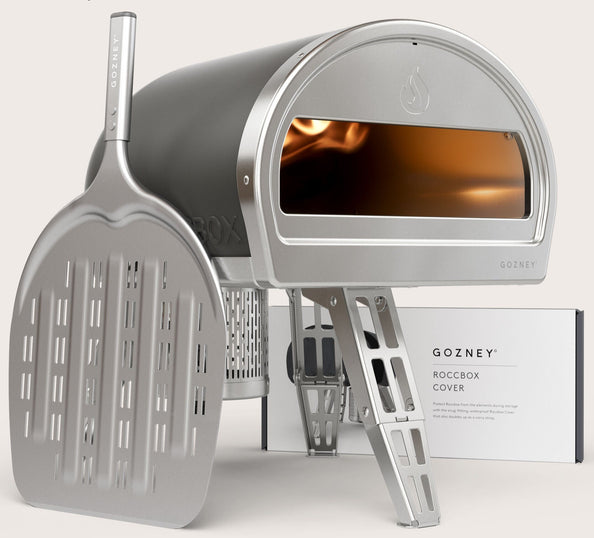 Grey Roccbox comes with oven, gas burner, gas regulator, pizza peel, bottle opener and user manual/recipe book by Gozney